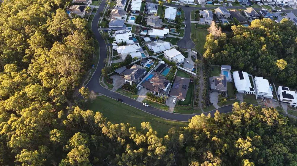 Aerial view of homes beside bushland on the Sunshine Coast