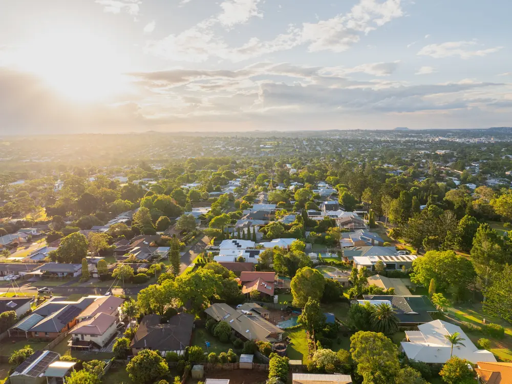 Aerial view across a leafy Sunshine Coast residential suburb