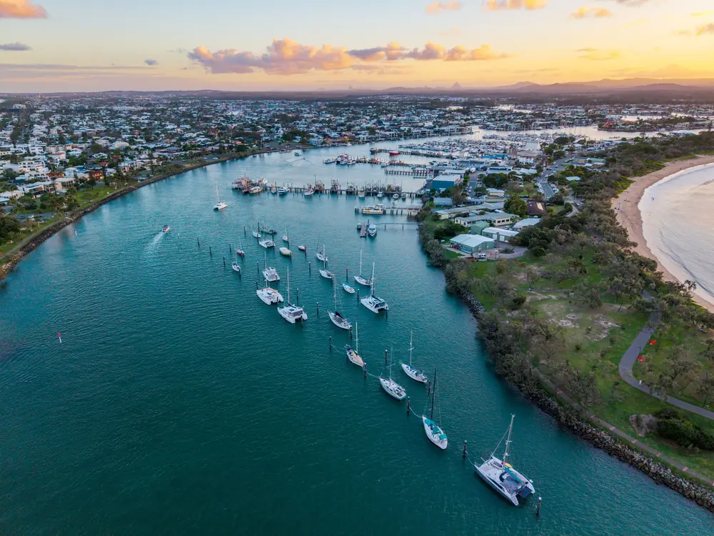 Aerial view of a river marina and surrounding Sunshine Coast neighbourhoods