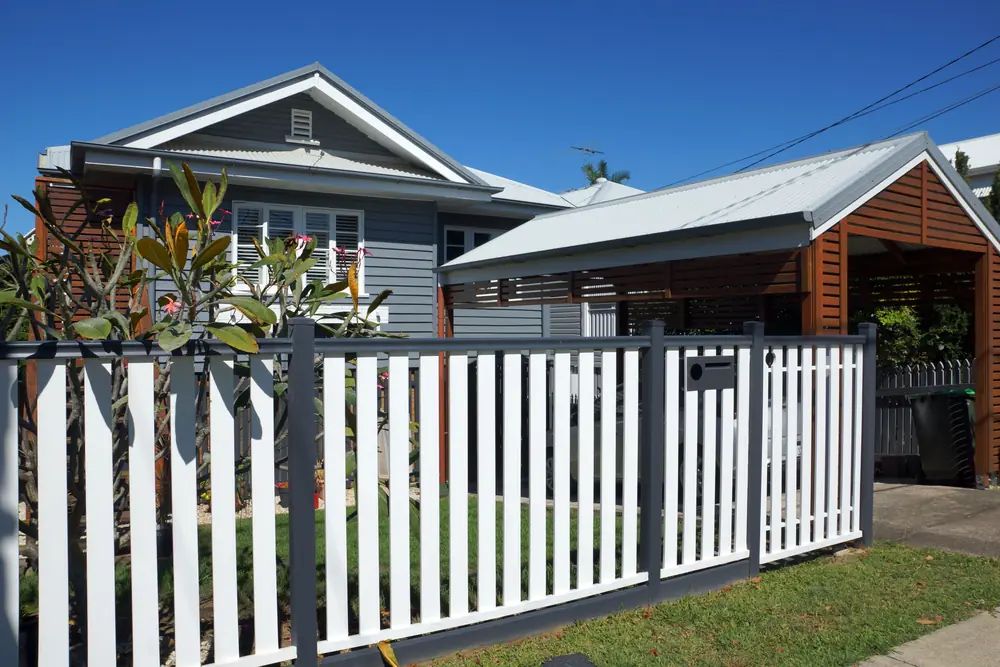 Detached Queensland home behind a white picket fence