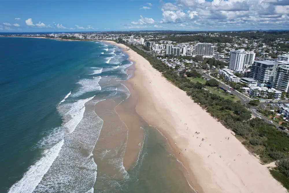 Aerial view along a Sunshine Coast beach and residential area